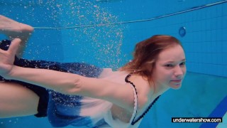 Teen girl Avenna is swimming in the pool