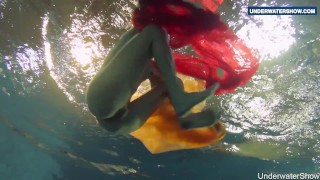 Yellow and Red clothed teen underwater