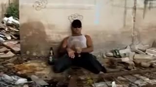 Stud is stroking his cock and pissing after slugging a beer